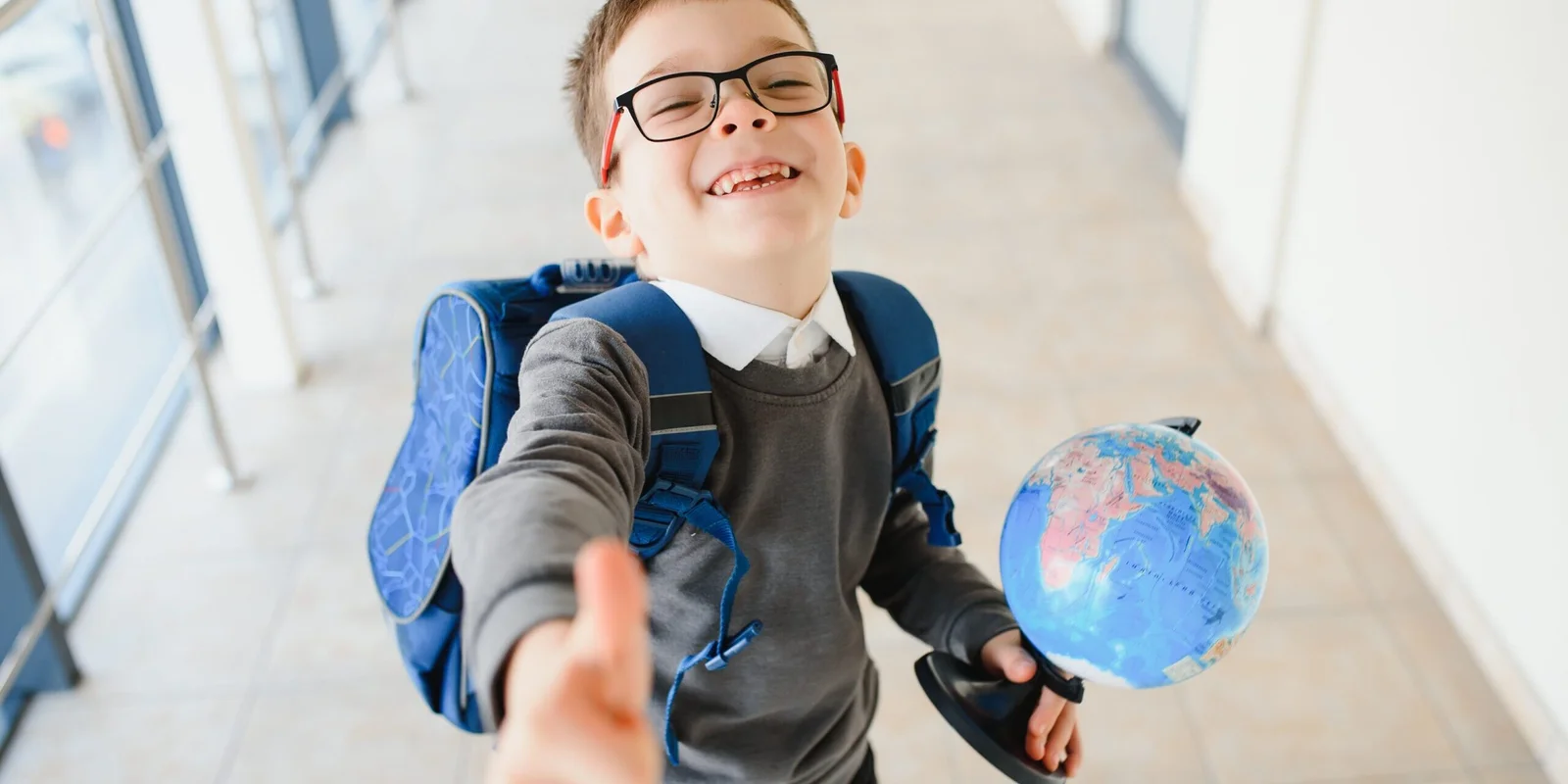Happy smiling boy in glasses is going to school fo 2024 01 08 21 25 06 utc scaled 2560x1280